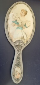 Hand painted mirror with image of a woman looking over her shoulder towards artist.