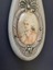 Portrait of man on handle of mirror