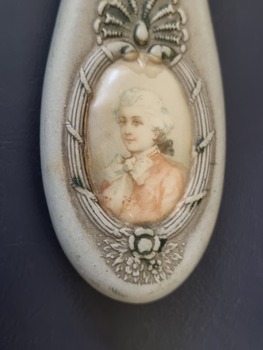 Portrait of man on handle of mirror