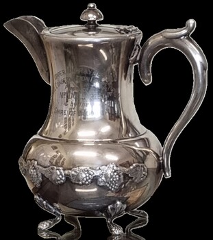 Ornate Silver teapot with engraving on front