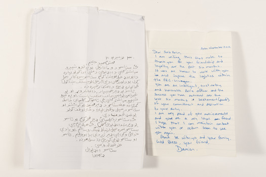 Two letters, one in Arabic and the second translated into English. Arabic letter is photocopied; English letter is written in blue pen. 