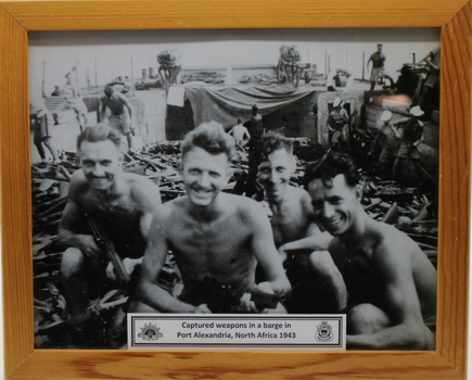 Photograph three soldiers working on a barge in Port Alexandra North Africa 