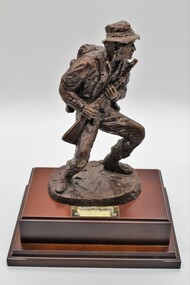 Sculpture of infantry soldier in traditional action pose.
