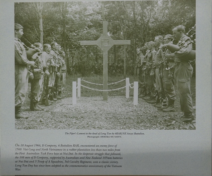 Sepia photograph in portrait format of piper and guard at Long Tan Cross, Vietnam