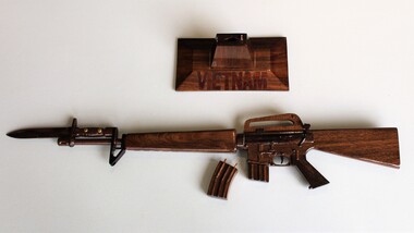 Wooden model of M16 rifle with 2 x magazines and a display stand.