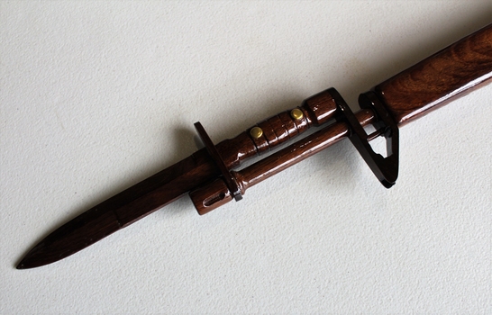 Wooden model of M16 rifle with 2 x magazines and a display stand.