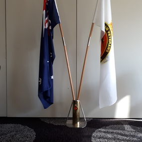 Centre piece comprising Australian and Vietnam Veterans Association of Australia flags in brass stand.