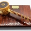 Comprises wooden plate made of dark coloured  timber with gavel made of lighter coloured timber
