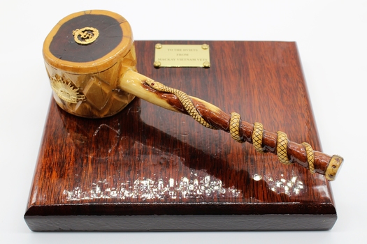 Comprises wooden plate made of dark coloured  timber with gavel made of lighter coloured timber