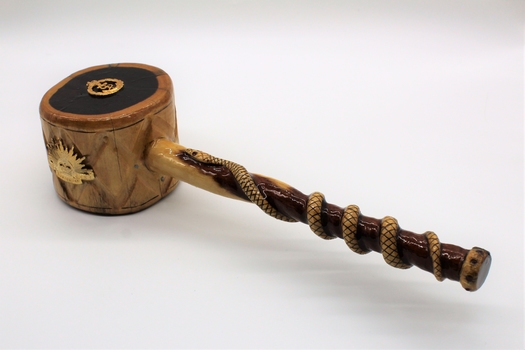 Comprises wooden plate made of dark coloured timber with gavel made of lighter coloured timber