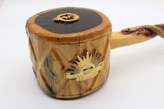 Comprises wooden plate made of dark coloured timber with gavel made of lighter coloured timber
