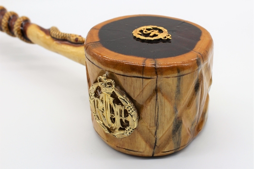 Comprises wooden plate made of dark coloured timber with gavel made of lighter coloured timber