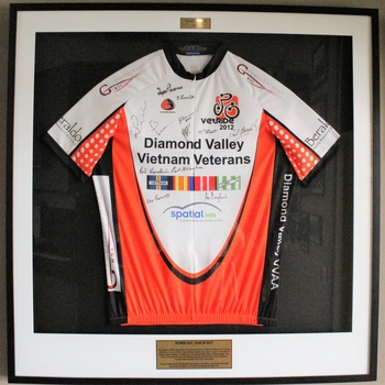 Framed VetRide jersey; orange and white set on a black blackground.