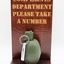 Novelty item: Hand Grenade for Complaints Department, 'Please take a number'.