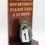 Novelty item: Hand Grenade for Complaints Department, 'Please take a number'.