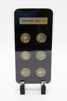 Commemorative pin collection on stand depicting elements of Australian Armed Services, Vietnam.
