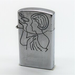 Period metal cigarette lighter; engraving of bird and girl on one side and text on reverse side. 