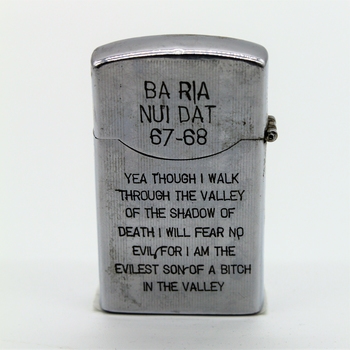 Period metal cigarette lighter; engraving of bird and girl on one side and text on reverse side. 