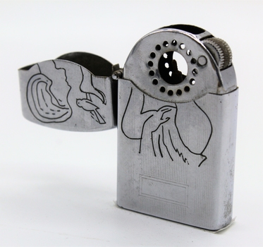 Period cigarette lighter; engraving of girl and bird on one side with engraving of text on the other side.