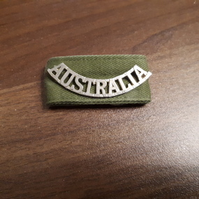 A uniform shoulder accessory, the word "Australia".
