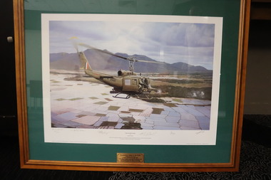 Huey in flight over rice paddy fields.