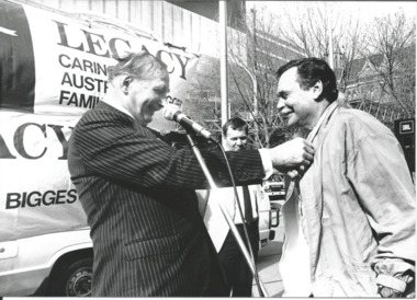 Sir Weary Dunlop and Ron Barassi at a Legacy Week event, a tug-of-war in the city square.