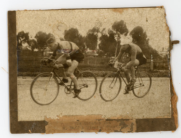 Photograph - Black and White Photograph, Two Cyclist on the road, trees in the background