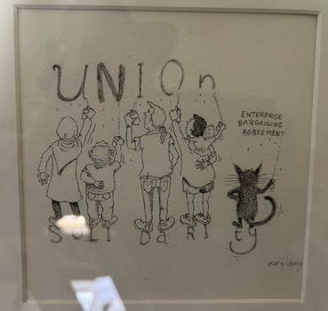 This is an original drawing by Mary Leunig of workers painting the word union while a cat is painting the words Enterprise Bargaining Agreement.