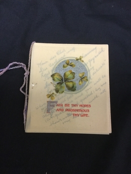 Cream Christmas greeting card with green leaf design printed on the celluloid cover.