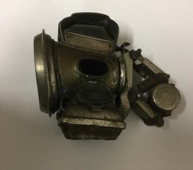 Metal Lamp with green coloured glass on side.