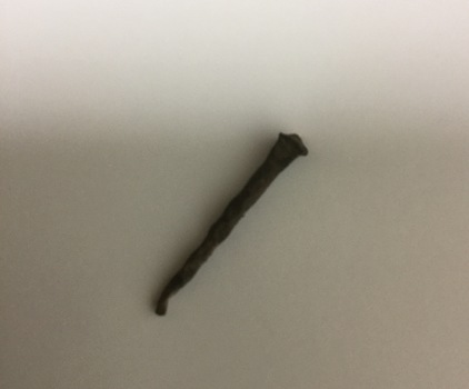 1 hand made nail, rusted.