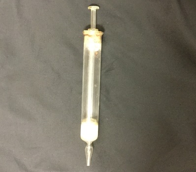 Glass hypodermic needle with plunger.