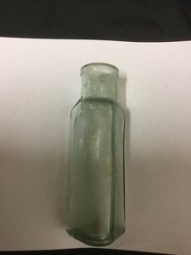 Green glass bottle, with triangular shaped bottom and no stopper