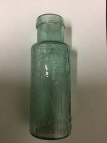 Green glass bottle with imprint of 'Bengal Chutney Co.  Imprint on front of bottle is Palm Trees, written underneath 'The Palms Brisbane' 