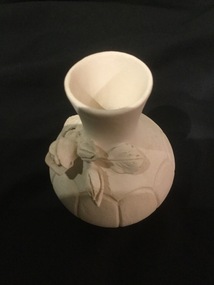 White Pottery vase with decorative rose buds.