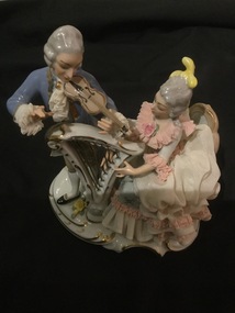 Dresden China - Musical couple - lady in white & pink dress with harp, and man with violin. Pink and white.