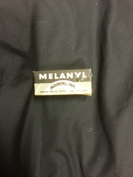 Black Melanyl Marking Ink in a yellow and black cardboard box.