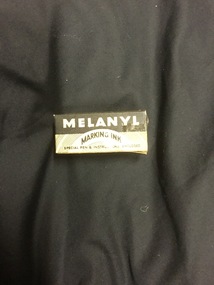 Black Melanyl Marking Ink in a yellow and black cardboard box.