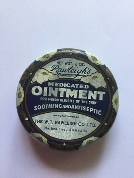 A small round blue and white floral patterned Rawleigh's medicated ointment tin with a lift off lid.