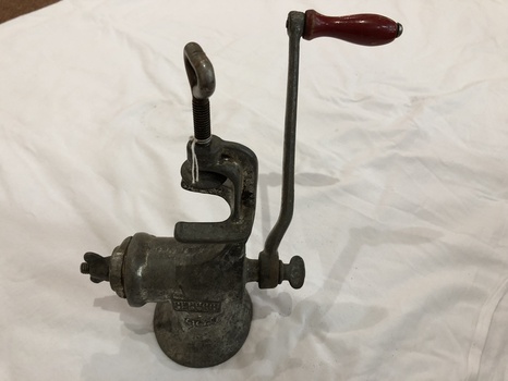 'Beatrice' brand cast iron mincer with a red wooden handle with two attachments. 