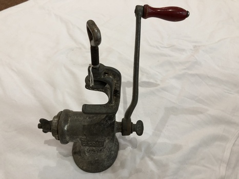 'Beatrice' brand vintage cast iron mincer with a red wooden handle with two attachments. 