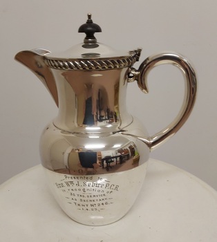Lidded silver coffee pot with twisted silver decoration around the top and a bakelite knob on lid.