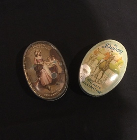 Two tins of Concrete Brilliantine with coloured pictures on the lids.