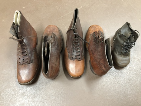 2 pairs of handmade, adult brown leather boots, with decorative stitching, eyelets and stitched with waxed thread. One child's boot.