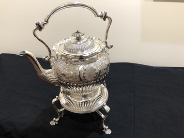 Silver teapot on stand