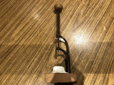 Cherry stoner with screw hand plunger into a porcelain receptacle.