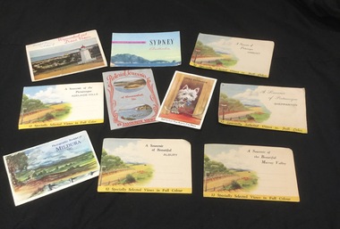 Nine packages of photo souvenir postcards from various Australian cities and towns and one single postcard of a Scottie dog.