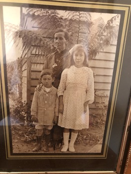 A group family photograph of a mother, Lily and her two children