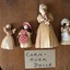 A set of nine assorted clothed handmade miniature dolls for children or display made from corn husks, pegs, straw and wood. 