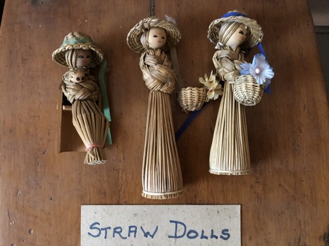A set of nine handmade clothed dolls from corn husks, pegs, straw and wood.